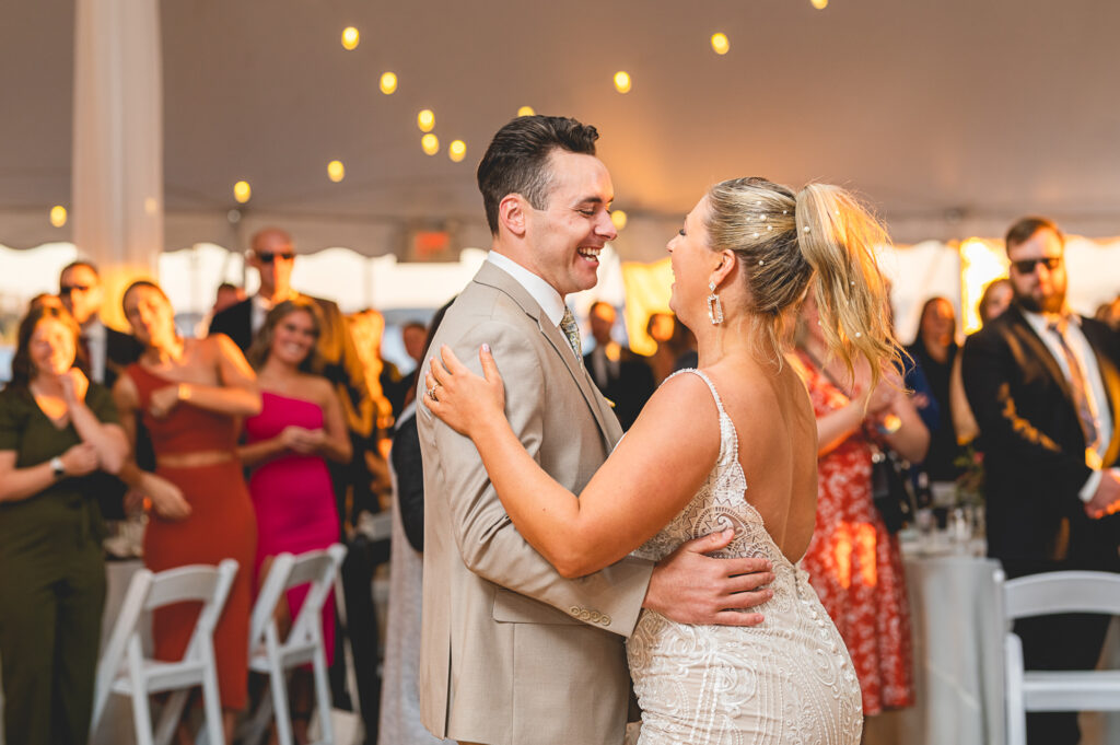 Wedding reception at the Herreshoff Marine Museum is Bristol, Rhode Island. A bride and groom dancing their first dance as husband and wife.