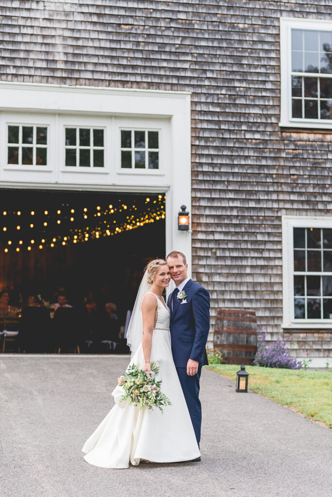 Wedding at Mt Hope Farm in Bristol RI. Bride and groom standing in front of the barn.