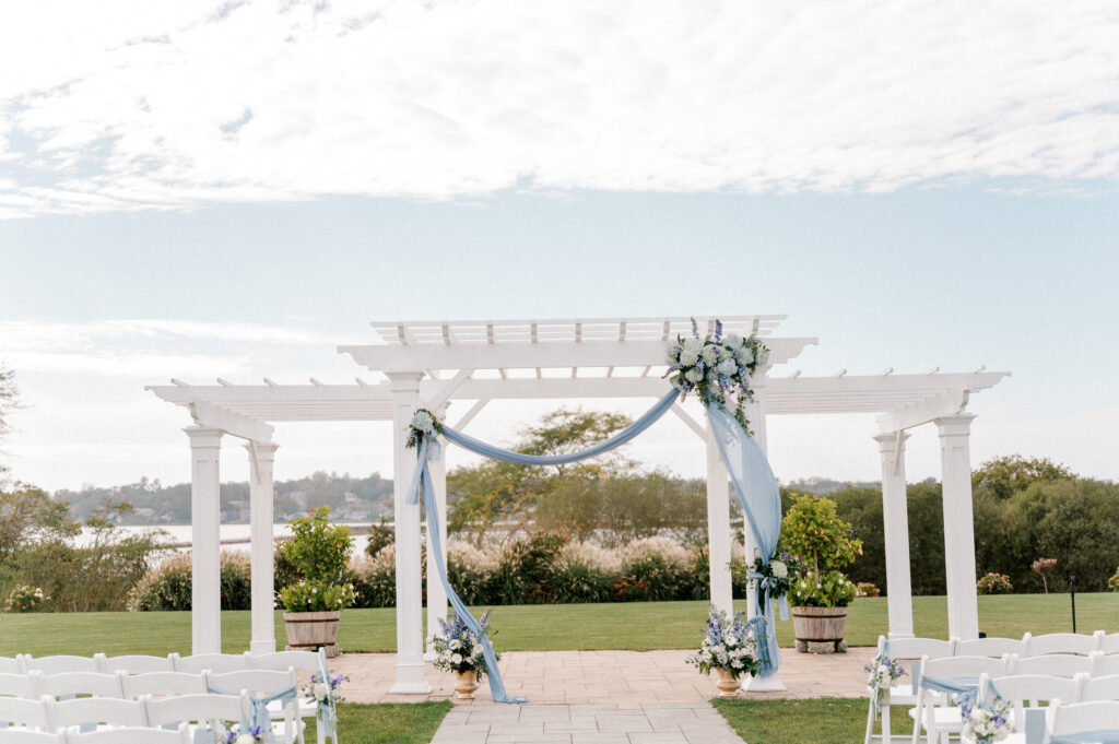 Dusty blue florals decorating the outdoor veranda for wedding ceremonies at the Wyndham Newport hotel.